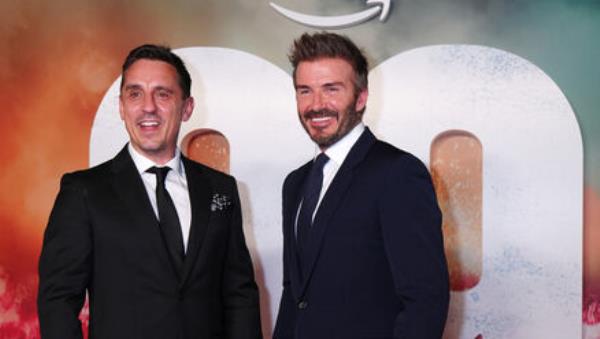 Gary Neville (left) and David Beckham arrive on the red carpet for the 99 World Premiere.