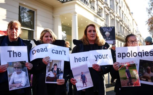 Protesters holds a placard reading 