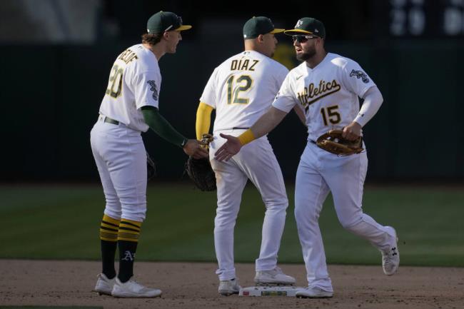 The A’s Zack Gelof (20) celebrates with Aledmys Diaz (12) and Seth Brown (15) after defeating the San Francisco Giants in Oakland, Saturday, Aug. 5, 2023. (Jeff Chiu / ASSOCIATED PRESS)