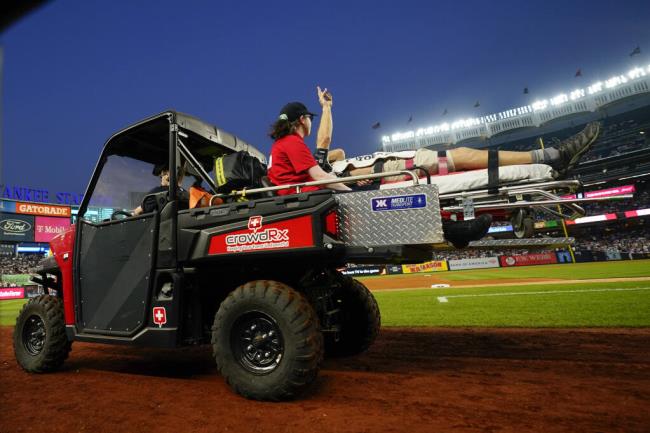 A camera operator who was hit on the head by a wild throw from the Baltimore Orioles’ Gunnar Henderson is carted off the field during the fifth inning of the Orioles’ game against the Yankees on Wednesday, July 5, 2023, in New York. (Frank Franklin II / ASSOCIATED PRESS)