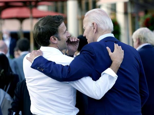 FILE - French President Emmanuel Macron whispers to U.S. President Joe Biden following their dinner at the G7 Summit in Elmau, Germany, June 26, 2022.