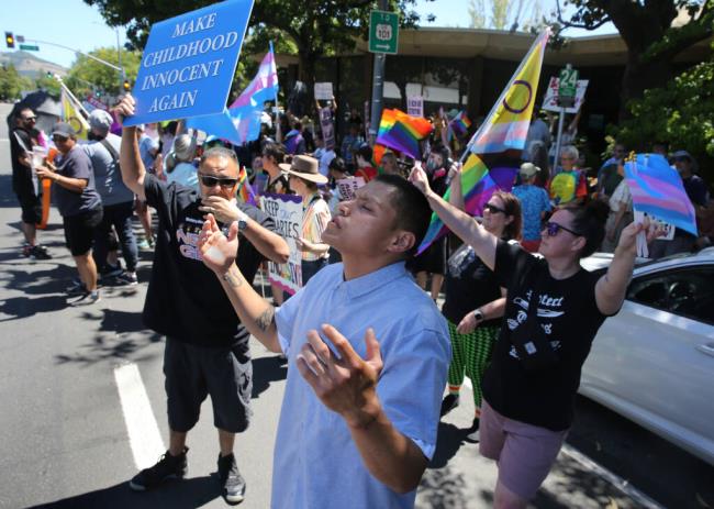 A man, who identified himself o<em></em>nly as a member of Victory Outreach Church, prays alo<em></em>ngside his fellow protesters of the Drag Story Hour outside the downtown Santa Rosa branch of the So<em></em>noma County Library in Santa Rosa, Sunday, June 18, 2023. (Beth Schlanker / The Press Democrat file)