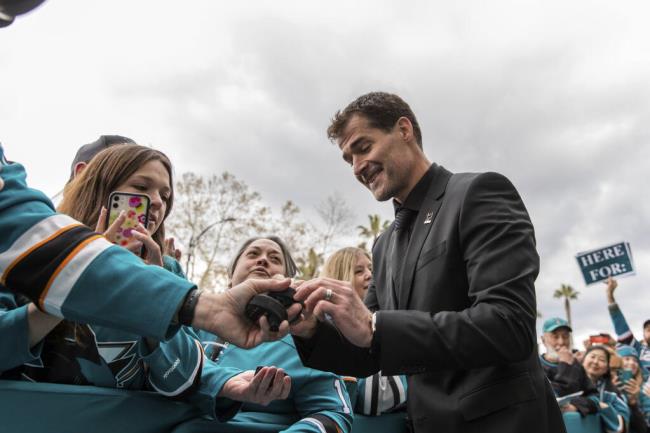 Former Sharks player Patrick Marleau, right, signs autographs before his No. 12 jersey was retired in San Jose, Saturday, Feb. 25, 2023. (John Hefti / ASSOCIATED PRESS)