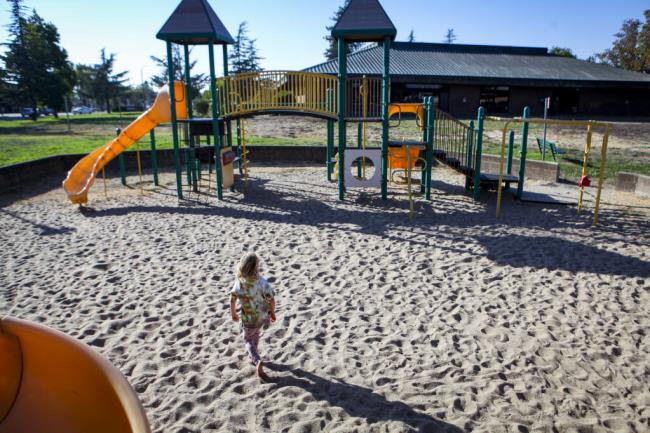 Aurora Altenreuther, 4, plays on the playground at Kenilworth Park. The city has hired an artist to help transform the playground next to the library. Tuesday, August 30, 2022. (CRISSY PASCUAL/Argus-Courier Staff)