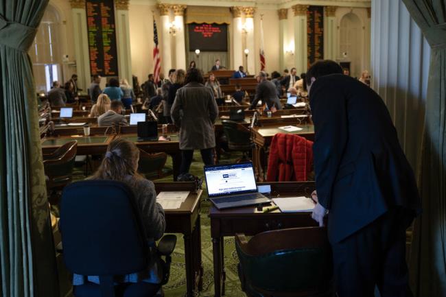 Capitol staffers at work on the Assembly floor on April 24, 2023. Photo by Miguel Gutierrez Jr., CalMatters